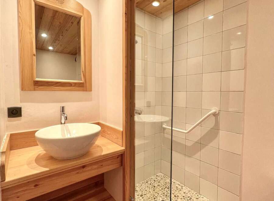 Discover the charm of this beautifully designed bathroom, featuring a stylish vessel sink and a spacious shower.