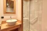 Discover the charm of this beautifully designed bathroom, featuring a stylish vessel sink and a spacious shower.