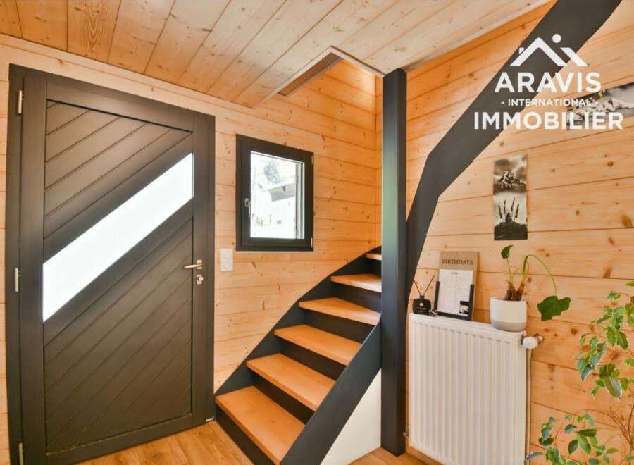 Discover the charm of this inviting interior, featuring a stylish staircase and warm wooden accents.
