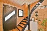 Discover the charm of this inviting interior, featuring a stylish staircase and warm wooden accents.