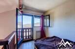 Discover a charming bedroom with stunning mountain views.