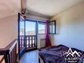 Discover a charming bedroom with stunning mountain views.