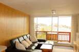 Enjoy breathtaking mountain views from this cozy living space.