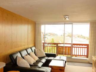 Enjoy breathtaking mountain views from this cozy living space.