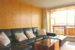This stunning property boasts a modern living space with a comfortable black leather sectional sofa, perfect for relaxation.