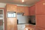 This charming kitchen features warm wooden cabinetry, creating a cozy and inviting atmosphere.