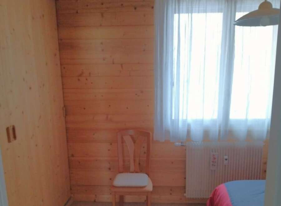 This cozy room features beautiful wooden paneling, creating a warm and inviting atmosphere.
