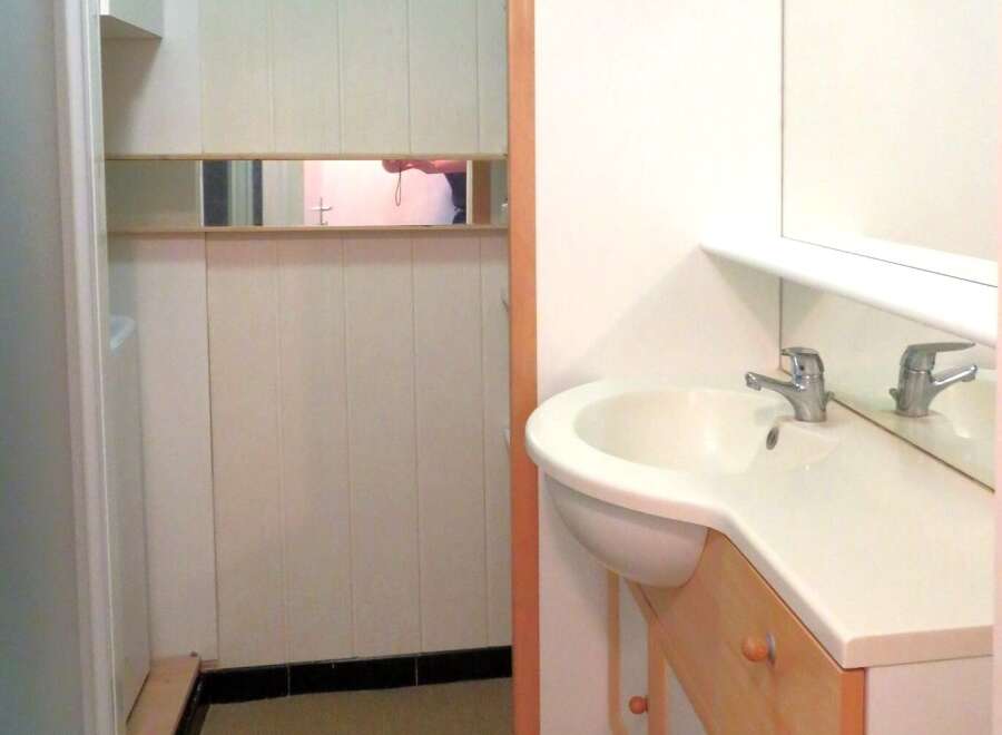 This well-maintained bathroom features a modern sink and a stylish vanity, perfect for daily routines.