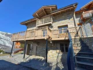 Discover the charm of this stunning stone-clad chalet, perfectly nestled in a picturesque mountain setting.