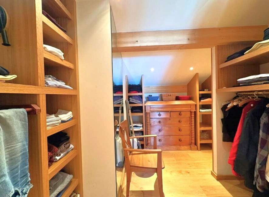 Step into luxury with this stunning walk-in closet, designed for both style and functionality.