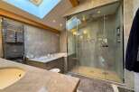 Step into luxury with this stunning bathroom featuring a spacious walk-in shower and a relaxing soaking tub.