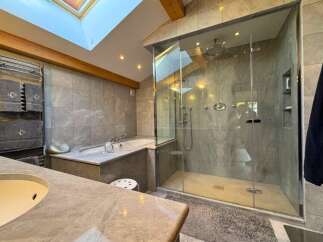 Step into luxury with this stunning bathroom featuring a spacious walk-in shower and a relaxing soaking tub.