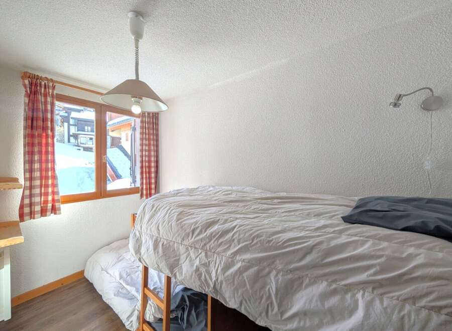 This cozy bedroom features a bunk bed, perfect for accommodating guests or family members.