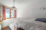 This cozy bedroom features a bunk bed, perfect for accommodating guests or family members.