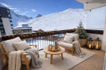 Enjoy breathtaking mountain views from this cozy balcony.