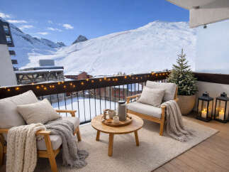 Enjoy breathtaking mountain views from this cozy balcony.