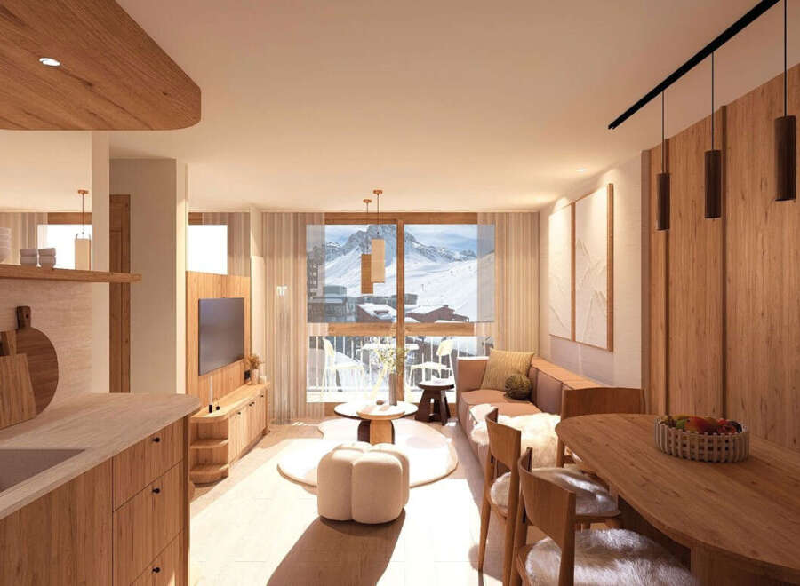 Experience modern alpine living in this beautifully designed apartment, featuring a spacious open-plan living area with a cozy seating arrangement and a dining space perfect for family meals.