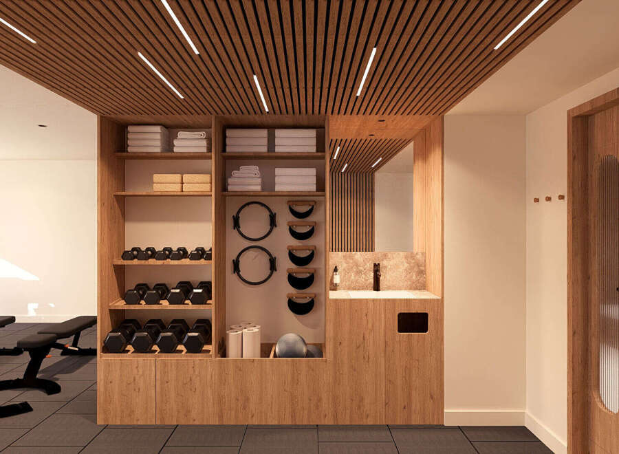 This modern gym features a sleek wooden ceiling with integrated lighting, creating a warm and inviting atmosphere.