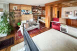 Step into this inviting living space, featuring a cozy seating area and a striking fireplace.