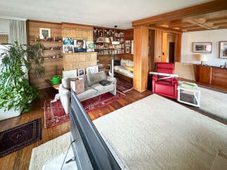 Step into this inviting living space, featuring a cozy seating area and a striking fireplace.