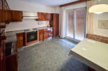 Discover this charming kitchen, featuring classic wooden cabinetry and a functional layout.