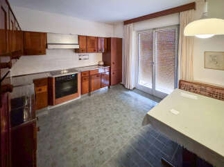 Discover this charming kitchen, featuring classic wooden cabinetry and a functional layout.