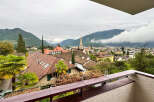 Enjoy breathtaking views from this stunning property! This home boasts a charming balcony overlooking a picturesque cityscape and majestic mountains.