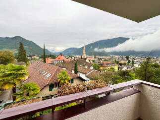 Enjoy breathtaking views from this stunning property! This home boasts a charming balcony overlooking a picturesque cityscape and majestic mountains.