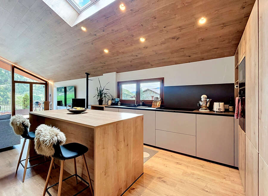 This stunning kitchen boasts a modern design with a warm, inviting atmosphere.