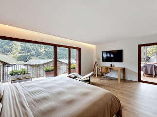 Experience luxury living in this stunning bedroom with breathtaking mountain views.