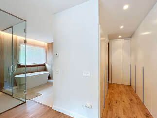 This modern bathroom features a sleek glass shower enclosure and a luxurious soaking tub, perfect for relaxation.