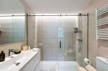 Step into a modern bathroom oasis! This stunning space features a sleek glass shower enclosure, perfect for a refreshing start to your day.