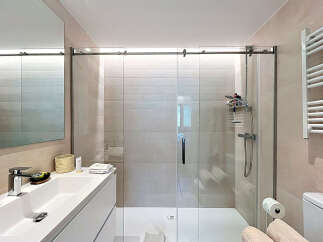 Step into a modern bathroom oasis! This stunning space features a sleek glass shower enclosure, perfect for a refreshing start to your day.