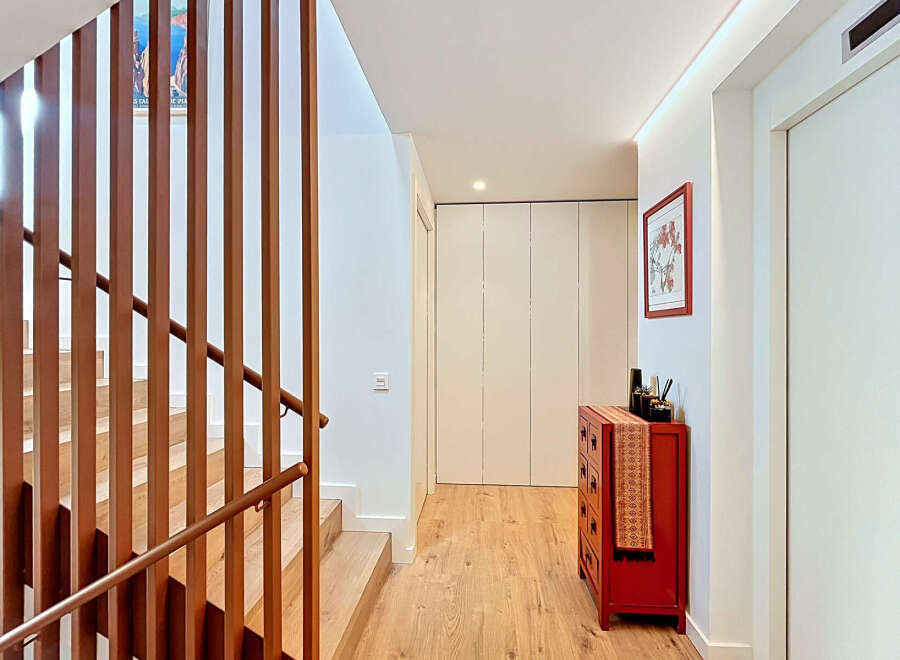 This stunning property boasts a modern interior with a beautiful wooden staircase and a bright, inviting hallway.