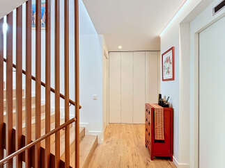 This stunning property boasts a modern interior with a beautiful wooden staircase and a bright, inviting hallway.