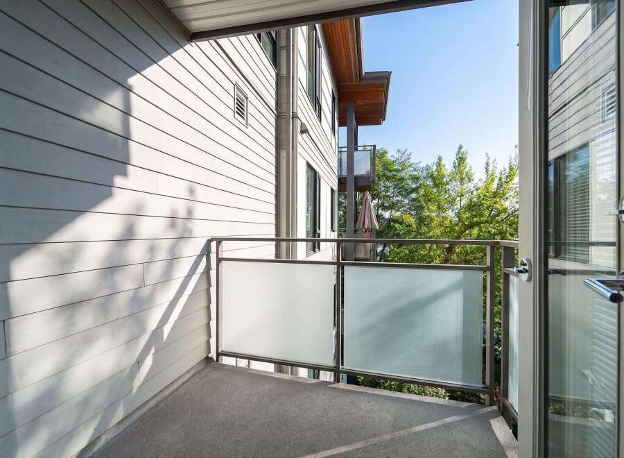 Enjoy the fresh air and stunning views from this modern balcony.