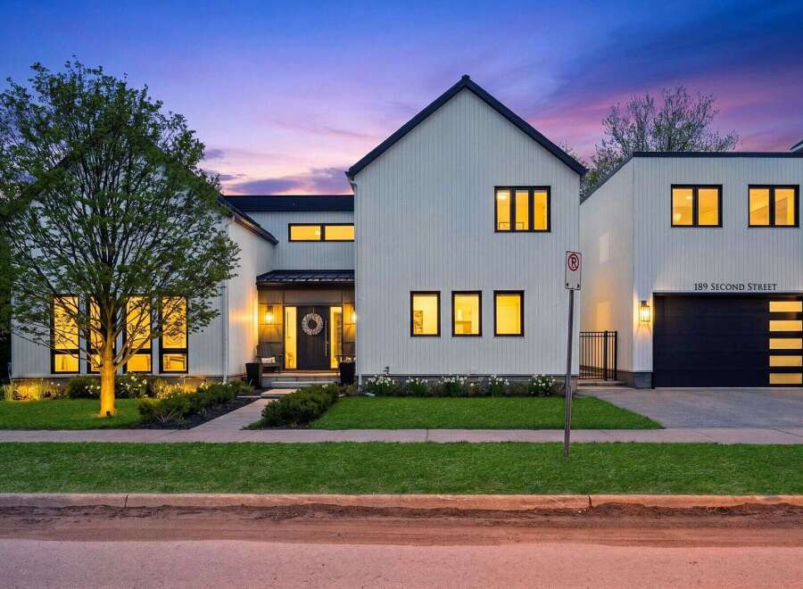 This stunning modern farmhouse boasts a striking exterior with clean lines and a welcoming entrance.