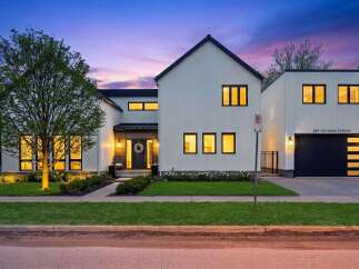 This stunning modern farmhouse boasts a striking exterior with clean lines and a welcoming entrance.