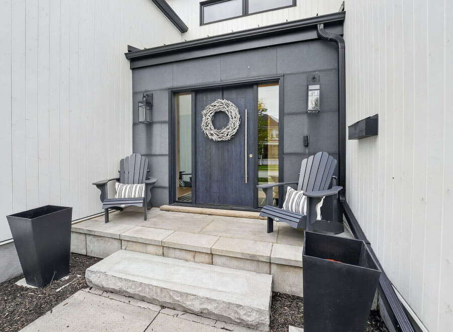 Welcome to your dream home! This stunning property boasts a modern exterior with a welcoming front porch.