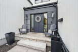 Welcome to your dream home! This stunning property boasts a modern exterior with a welcoming front porch.