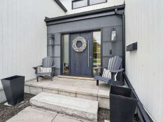 Welcome to your dream home! This stunning property boasts a modern exterior with a welcoming front porch.