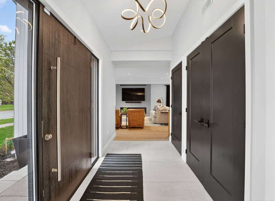 Step into luxury with this stunning entryway! The modern design features a sleek front door, elegant lighting, and a welcoming atmosphere.