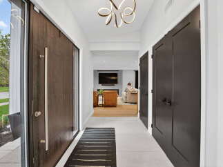 Step into luxury with this stunning entryway! The modern design features a sleek front door, elegant lighting, and a welcoming atmosphere.