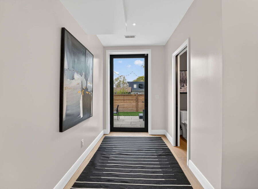 Step into this inviting hallway, showcasing a modern aesthetic with its sleek design and neutral color palette.