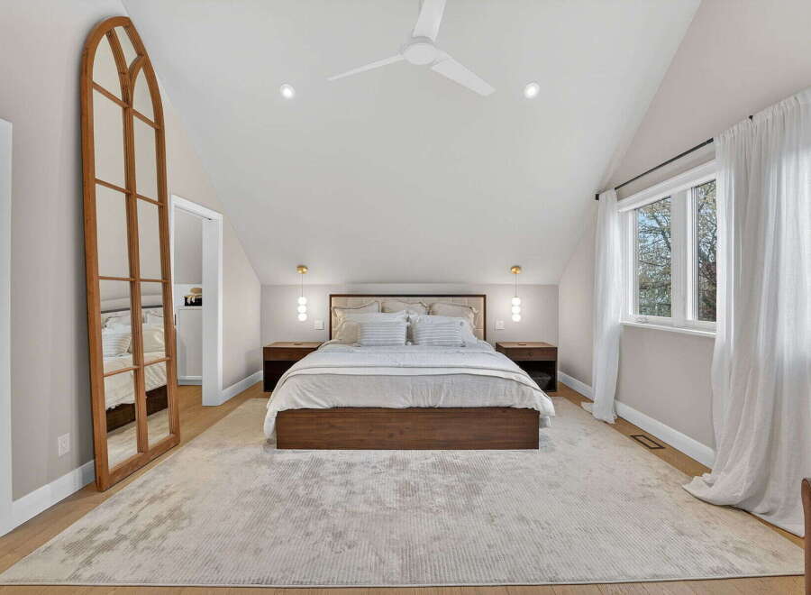 Step into this stunning bedroom, featuring a luxurious king-size bed and a spacious layout.