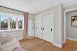 Step into this bright and airy bedroom, featuring a large window that floods the space with natural light.