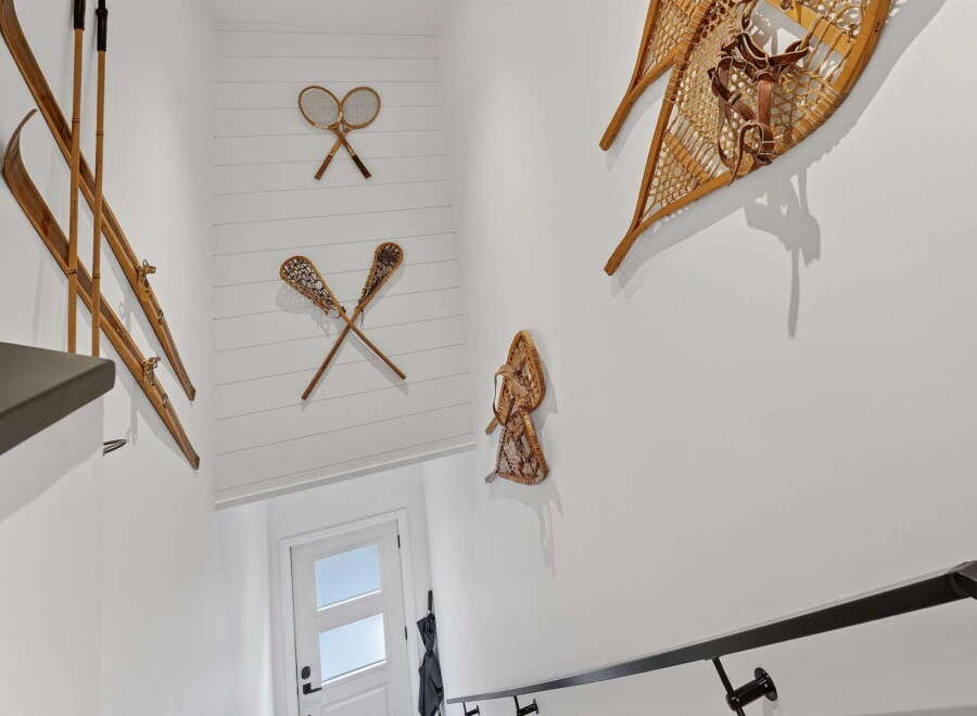 This stunning property boasts a unique interior design with vintage sports equipment adorning the walls, creating a charming and rustic aesthetic.