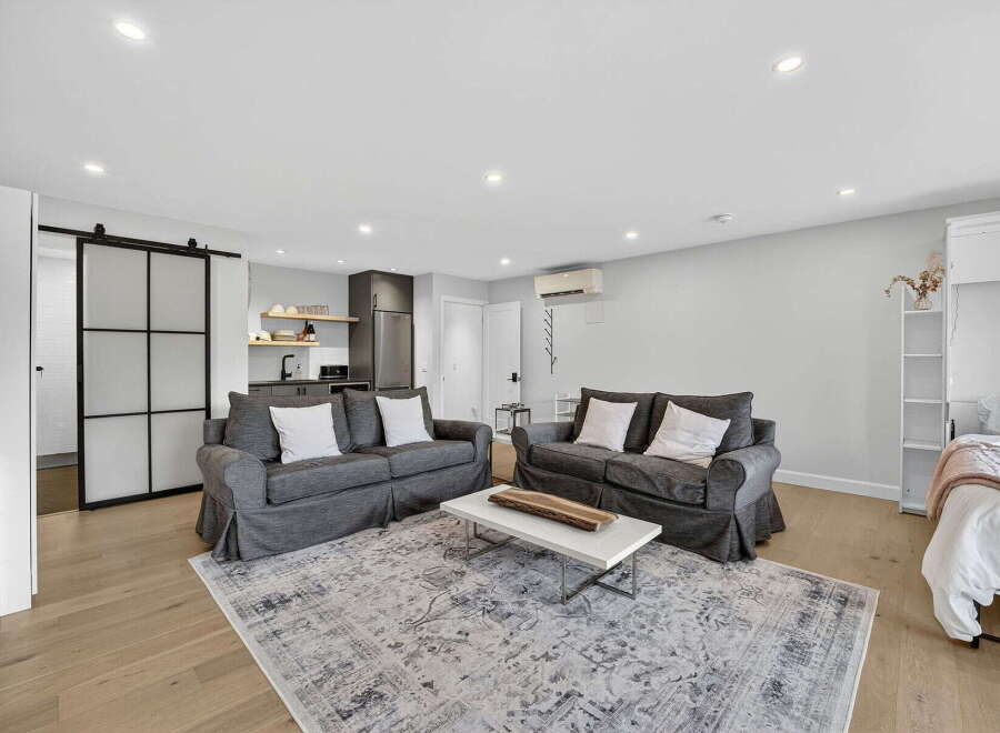 Discover modern living in this stylish apartment featuring a cozy living area with two comfortable sofas and a chic coffee table.