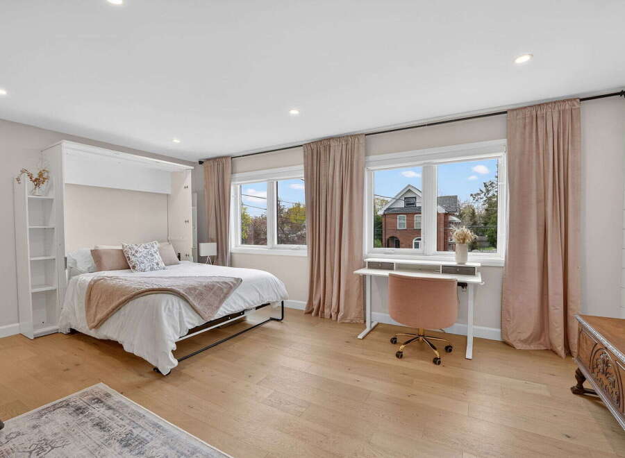 Step into this beautifully designed bedroom, featuring a convenient wall bed for maximizing space.