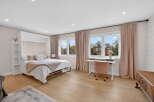 Step into this beautifully designed bedroom, featuring a convenient wall bed for maximizing space.